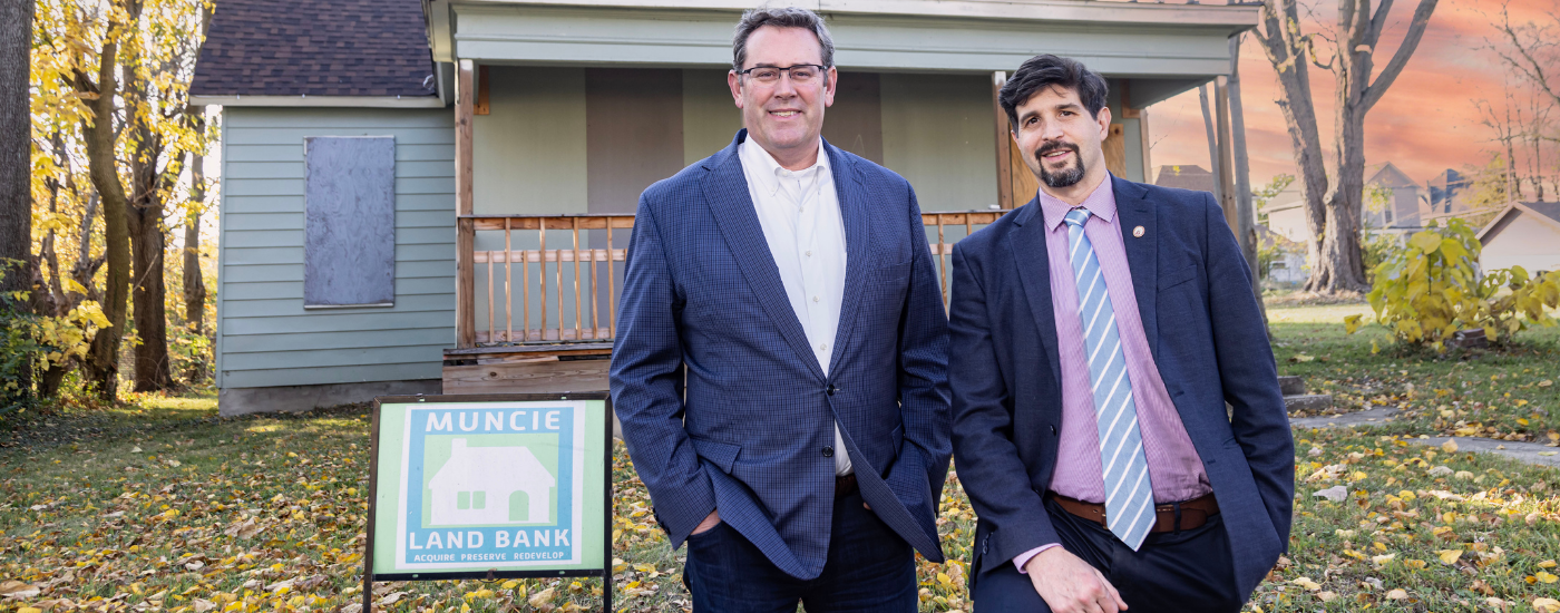 Ball Brothers Foundation President/CEO Jud Fisher (left) and 2024 Fisher Governance Award recipient John West stand outside a Muncie Land Bank property. West was honored for his exceptional board leadership advancing neighborhood revitalization efforts across the community.