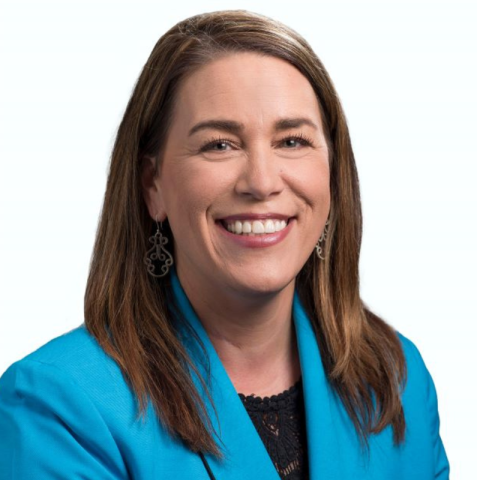 Laura Macknick, woman with a teal suit