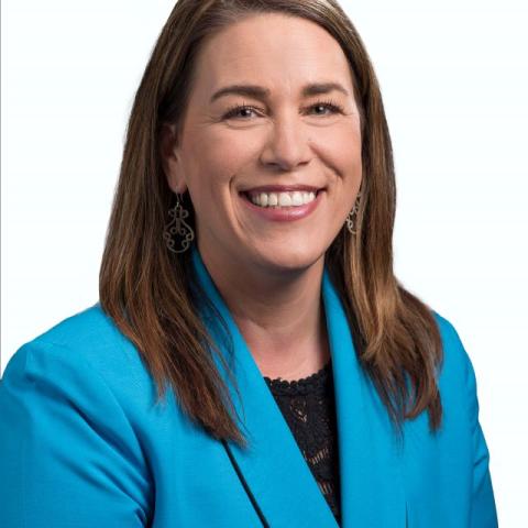 Laura Macknick, woman with a teal suit