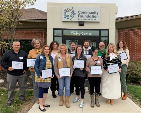 Graduates of Civic Circle posing in front of the community foundation's building.