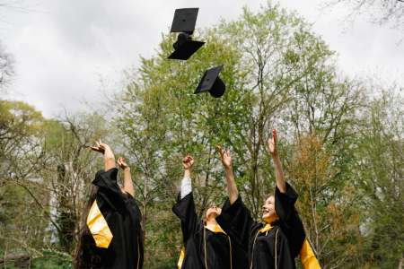 Graduates throwing cap in the air