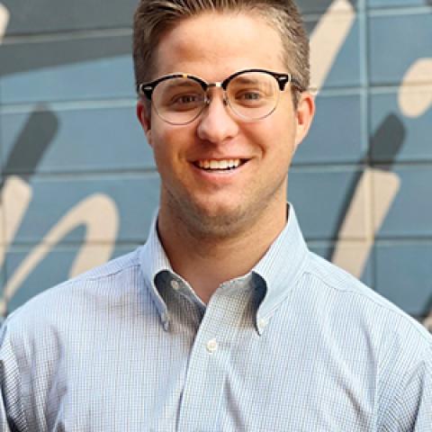 Caucasian man with glasses and light button down shirt