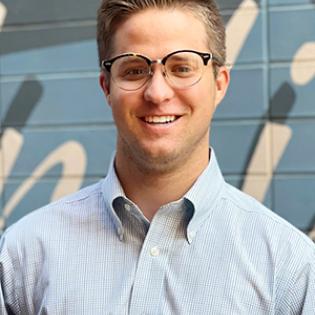 Caucasian man with glasses and light button down shirt